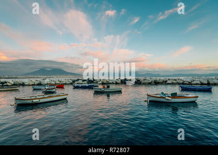 Boats and Mount Vesuvius at sunset, in Naples, Italy Stock Photo