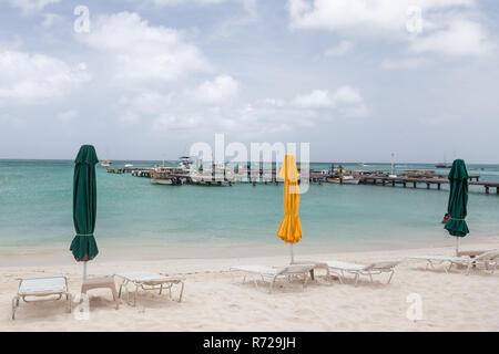 Umbrellas and chairs lined up on a beach. Stock Photo