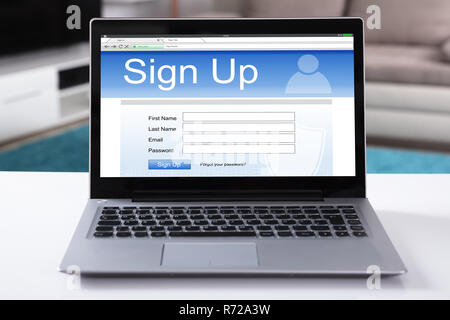 Close-up Of A Laptop With Online Sign Up Form On Screen Over White Desk Stock Photo