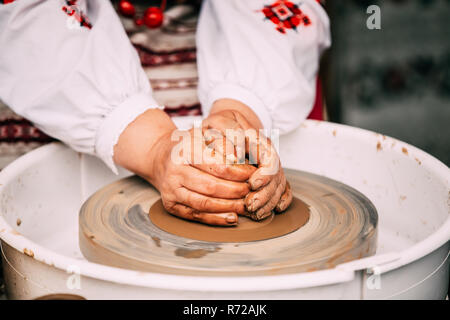 Process Of Creating A Clay Pot. Using Hands. Pottery Craft Wheel And Ceramic Clay Pot Stock Photo