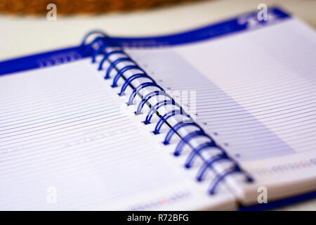 Open spiral notebook with lined sheets to write important appointments of the day. Business and productivity concept. Stationery object. Stock Photo