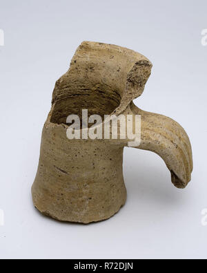 Neck fragment of jug with part of rim and ear, amphora jar holder soil find ceramic pottery, hand-turned baked neck fragment. Roman jug. Yellow-gray pottery. Blasted with gritty material. Profiled ear with three grooves. Neck with cuff collar archeology indigenous pottery import transport store save save Roman Stock Photo