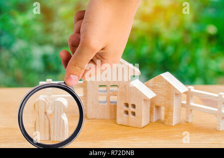 the family stands near their home. concept of real estate. buying, selling, renting a house. property insurance. affordable housing for young families Stock Photo