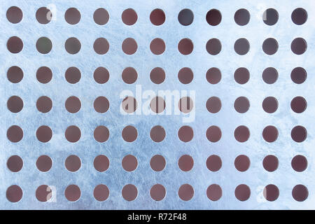 Steel patterned background with holes Stock Photo