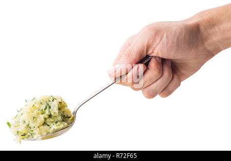 Hand holds a spoon on which the young boiled potatoes in dill isolated on white background. Clipping Path. Full depth of field. Stock Photo