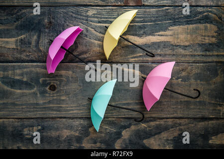 Colorful Mini Umbrellas on Blue Wooden Background Stock Photo