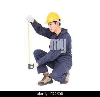 Young worker in unifrom with tape measure isolated on white Stock Photo