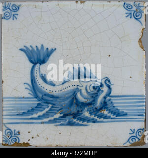 Scene tile, in tile field of eight, four high, two wide; blue, dolphin at sea, corner motif ox's head, tiled field wall tile tile sculpture part ceramic earthenware glaze tin glaze, baked 2x glazed painted Blue on white. Tile in tile field of eight pieces four high two wide. Stock Photo