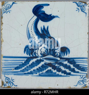 Scene tile, in tile field of eight, four high, two wide; blue, dolphin at sea, seen from the front, corner motif ox's head, tile field wall tile tile image part ceramic earthenware glaze tin glaze, baked 2x glazed painted Blue on white. Tile in tile field of eight pieces four high two wide. Stock Photo