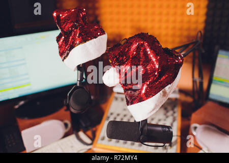 Condenser microphone in vocal recording room studio Santa Claus hat, new year Stock Photo
