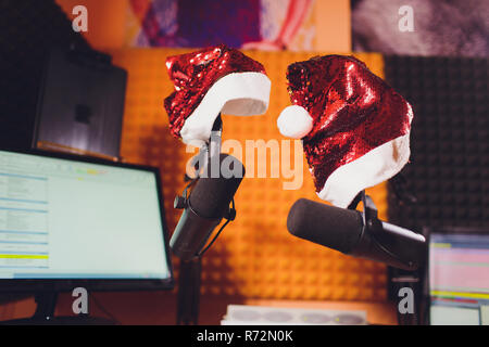 Condenser microphone in vocal recording room studio Santa Claus hat, new year Stock Photo