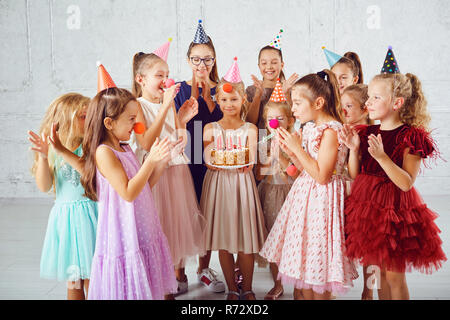 Children with a birthday cake have fun. Stock Photo