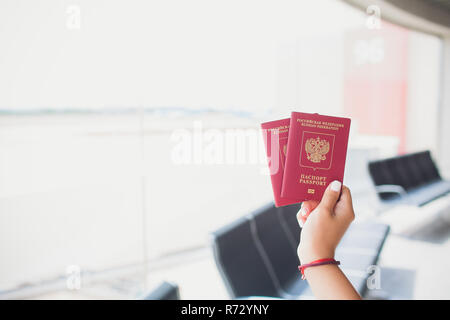BARCELONA, SPAIN - AUGUST 10, 2018: Two russian passports in hand. Russian official document on wooden background Stock Photo