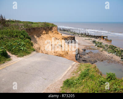 Severe coastal erosion leading to the loss of a road in the Norfolk village of Happisburgh Stock Photo