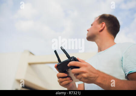 A process of launching the quadcopter drone with camera, operator launches quadcopter uav, unmanned aerial vehicle flying Stock Photo