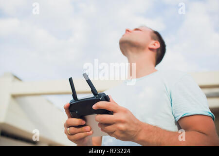 A process of launching the quadcopter drone with camera, operator launches quadcopter uav, unmanned aerial vehicle flying Stock Photo