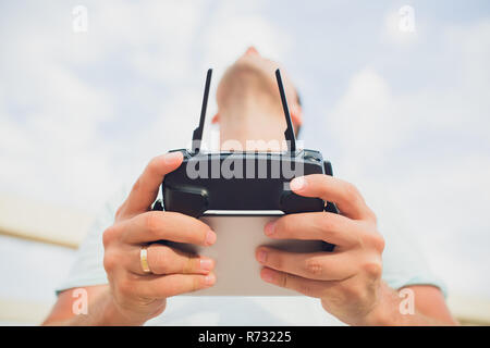 A process of launching the quadcopter drone with camera, operator launches quadcopter uav, unmanned aerial vehicle flying Stock Photo