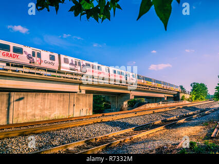 A MARTA (Metropolitan Atlanta Rapid Transit Authority) train passes on the railroad track behind The Frosty Caboose in Chamblee, Georgia. Stock Photo