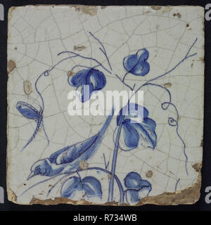 Blue tile of chimney pilaster with 13 tiles, bird tending down on grape branch and dragonfly, chimney pilaster tile pilaster footage fragment ceramics pottery glaze, Three blue tiles with bird dragonflies butterfly grape leaves possible from the same chimney pilaster with 13 tiles tree of bunches of grapes with birds grain leaves foot unknown. Stock Photo