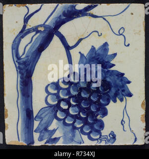 Blue grape stems with stem and dragonfly on the bunch of grapes, belonging to chimney pilaster with 13 tiles, tree of bunches of grapes with birds, insects, grain and leaves, tile pilaster footage fragment ceramic earthenware glaze, in black paint D 3. Stock Photo