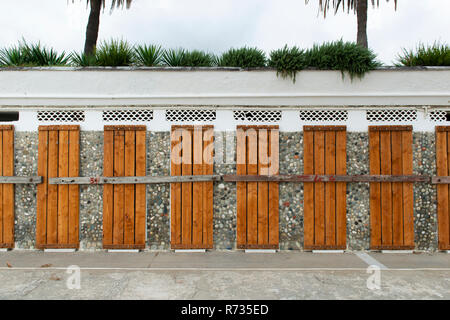 Doors covered and locked with wooden planks to protect them from winter weather and sea storms Stock Photo