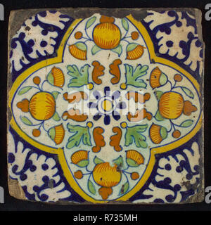 Ornament tile, centrally rosette above which orange-pineapples and marigolds, four-sided frame, corner motif, wall tile tile sculpture ceramics pottery glaze, baked 2x glazed painted Yellow and red shard square two nail holes. Multicolored: blue yellow orange brown green on white fond Ornament central decor. Square tile with flower with orange or yellow heart and blue leaves with oak leaves interspersed with stylized brown leaves around each round an orange apple with stylized marigold leaves and flower buds on both sides Rotterdam education Academy of Fine Arts and Technical Sciences Cool Coo Stock Photo