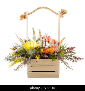 Flowers bouquet arrangement in pine basket isolated on white background. Stock Photo