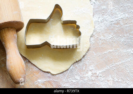 I like baking food concept with thumbs up cookie cutter on wooden background Stock Photo