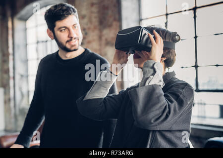 Designers testing virtual reality headset in studio Stock Photo