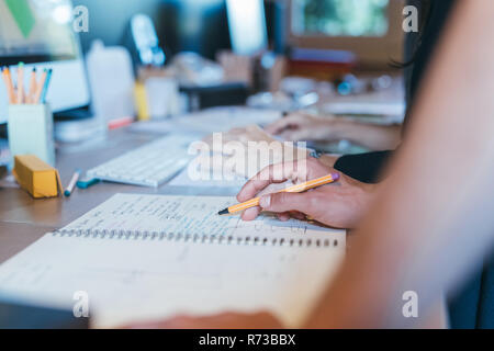 Papers and notes on busy desktop Stock Photo