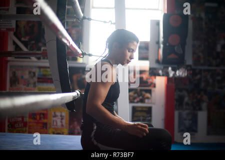 Female boxer by boxing ring Stock Photo