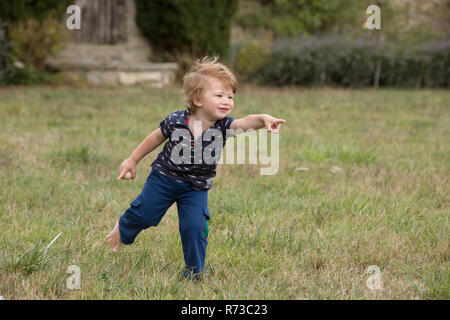 Boy eagerly pointing with finger Stock Photo