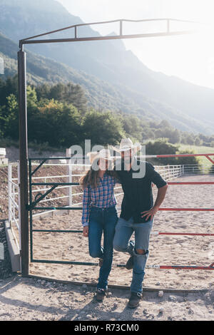 Cowgirl and boyfriend in rural equestrian arena, portrait, Primaluna, Trentino-Alto Adige, Italy Stock Photo