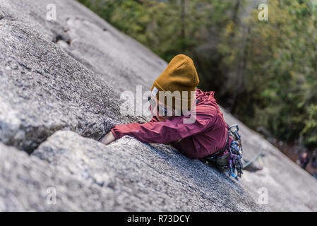 Rock climber gripping onto cracks, Malamute, Squamish, Canada Stock Photo
