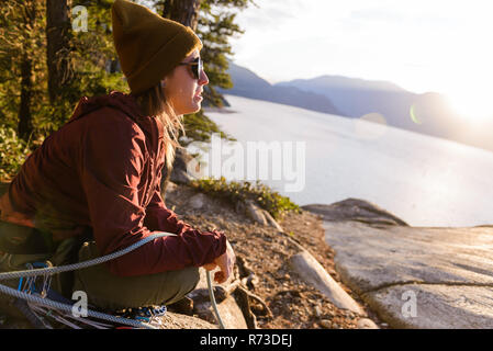 Rock climber enjoying sunset on Malamute, Squamish, Canada
