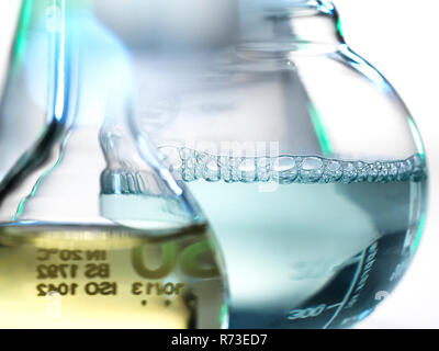 Laboratory beakers containing chemical formulas Stock Photo