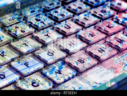Multiple exposure of laptop computer showing keyboard and circuit board below Stock Photo