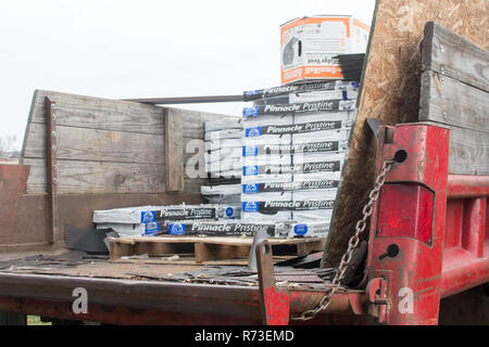 Roofing materials in the back of a dump truck. Stock Photo