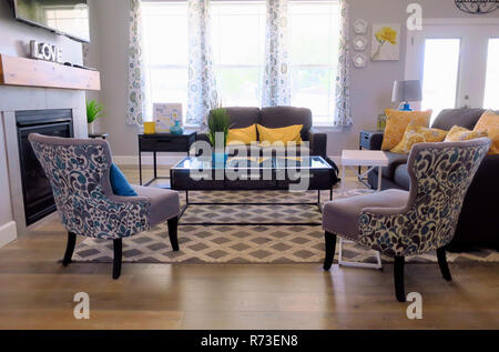 Chairs and couched centered around a table in a living room Stock Photo