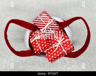 Various size wrapped in red paper with ornament Christmas gift boxes in red Christmas bag Stock Photo