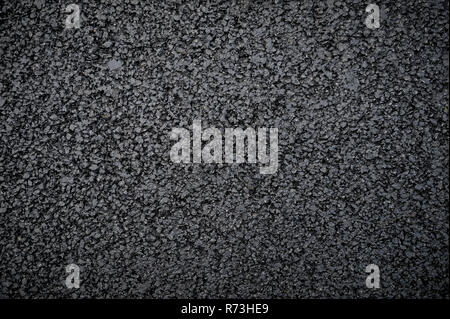 Textured abstract view of fresh new flattened asphalt in a full frame close up background Stock Photo