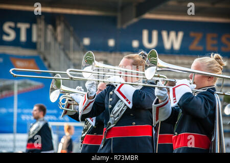 Details from a music, show and marching band. Playing musicians wind instruments in uniforms. Trombone Stock Photo