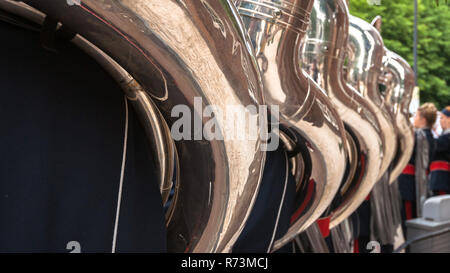 Details from a music, show and marching band. Playing musicians wind instruments in uniforms. Tuba, Sousa Stock Photo