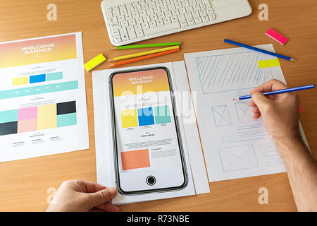 Creative sketch planning application process development prototype wireframe for web mobile phone. Graphic designer creating landing page for new webs Stock Photo