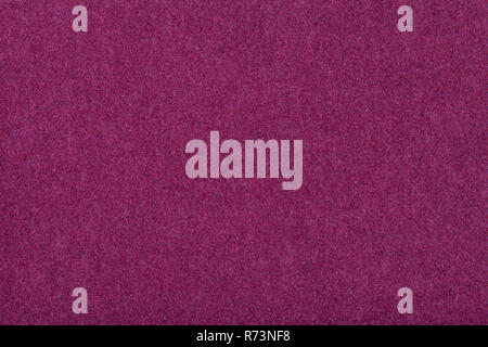 Dark purple matte background of suede fabric, closeup. Velvet texture of seamless wine woolen felt. Stock Photo
