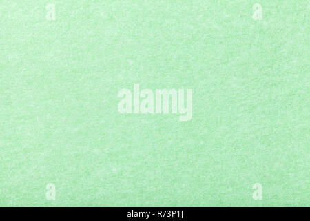 Light green matte background of suede fabric, closeup. Velvet texture of seamless mint woolen felt. Stock Photo