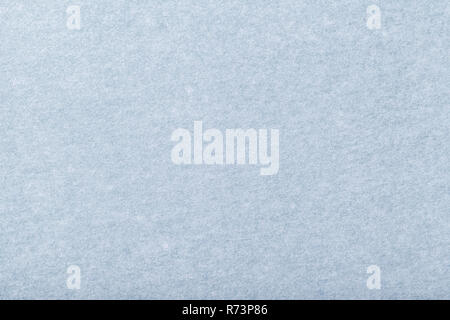Light blue matte background of suede fabric, closeup. Velvet texture of seamless steel woolen felt. Stock Photo