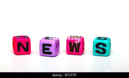 news - word made from multicolored child toy cubes with letters Stock Photo