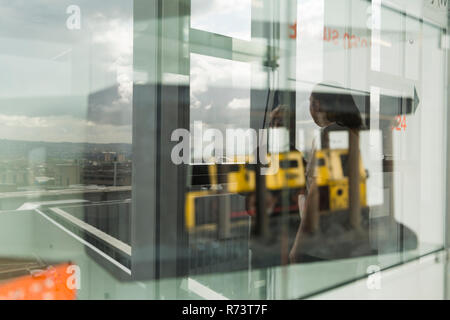 reflection of students in display cabinet at City of Glasgow College Stock Photo