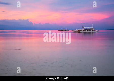 Stunning view of the sunset on the Philippine beach. Doljo beach, Panglao, Bohol, Philippines. Stock Photo
